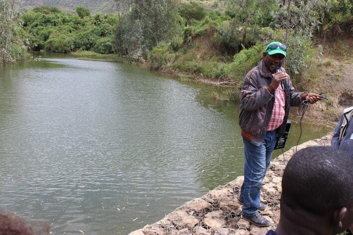 photo of river and lecturer: Fresh water, the reward of land restoration, flows in Ethiopia’s dry zone