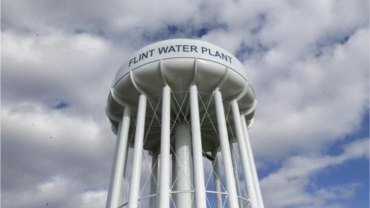 photo: Flint water tower; Study: Fewer pregnancies, more fetal deaths in Flint after lead levels rose in water