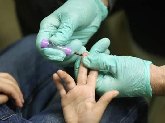 photo: blood being drawn - the ACLU wants Flint kids screened for impact of lead